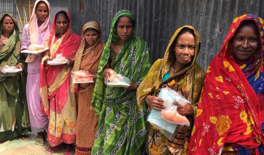 Women in a program cohort receiving supplies in the field